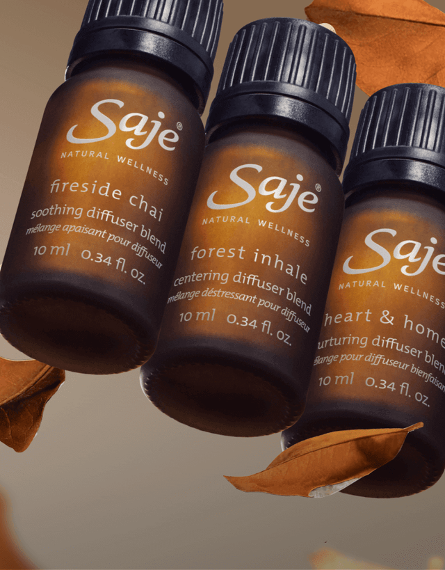 Three Saje diffuser blend bottles floating against a light brown background